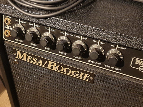 Close-up of a Mesa Boogie Mark III guitar amplifier from 1987, featuring a microphone positioned in front for recording.