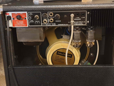 Close-up of a Mesa Boogie Mark III guitar amplifier from 1987, showcasing its speaker and detailed controls.