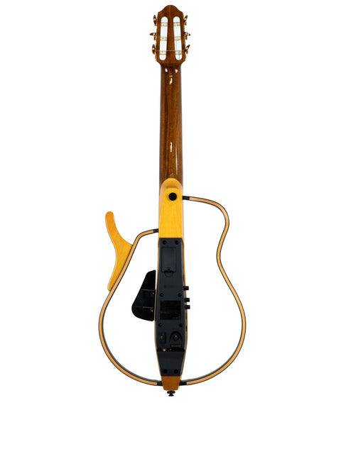 Close-up of a Yamaha SLG 120NW Silent Guitar featuring a bright yellow body and contrasting black strings, from Japan 2009.