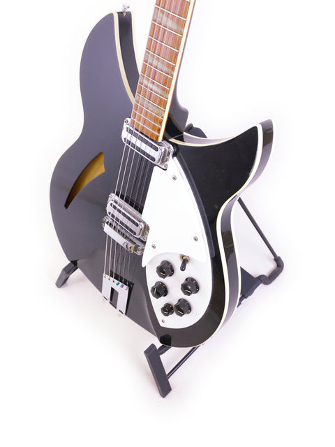 Close-up of a black Rickenbacker 360 WB guitar featuring a white pickguard, crafted in the USA in 1996.