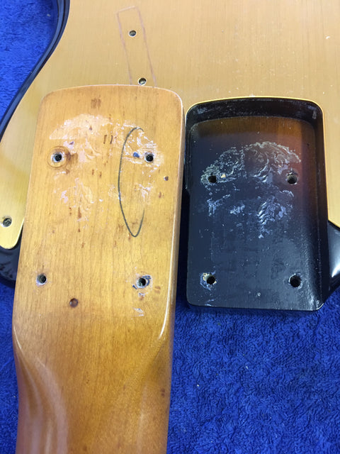 Close-up of a vintage 1958/59 Fender Precision Bass neck, showcasing its intricate details and craftsmanship.