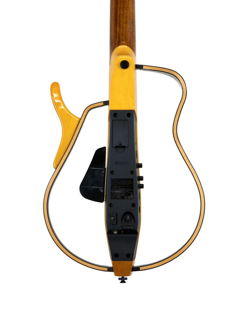 Close-up of a yellow Yamaha SLG 120NW Silent Guitar featuring a black pickup, crafted in Japan in 2009.