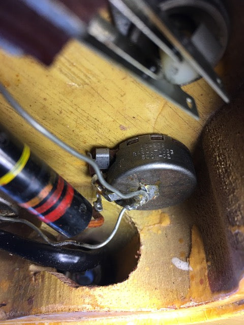 Close-up of an electrical device within a wooden box, featuring the vintage 1958 Gibson Les Paul Special Double Cut.

