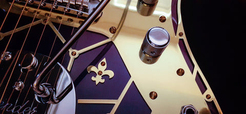 Close-up of the Zachary & Mercer Mastermind "Royal" Offset guitar, highlighting its eye-catching gold and purple accents.