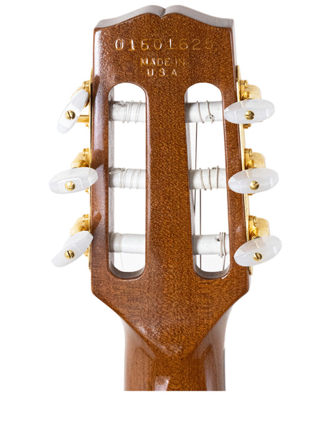 Close-up of the headstock from a 2001 Gibson Chet Atkins CEC Classical Electric Guitar, set against a clean white backdrop.