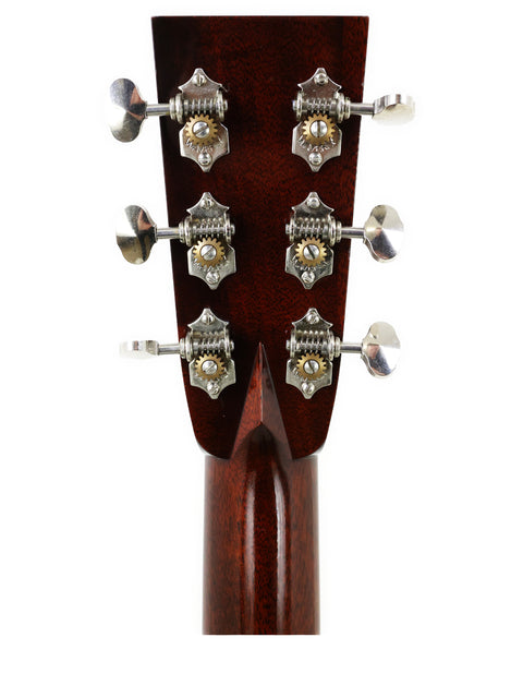 Close-up of the headstock from a 2006 Collings D2H acoustic guitar, highlighting four tuning knobs and elegant wood finish.
