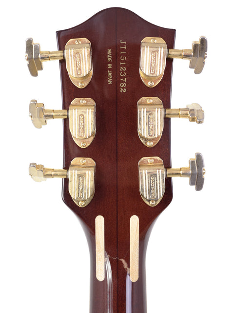 Close-up of the headstock from a 2015 Gretsch 6122T Chet Atkins Country Gentleman, emphasizing its rich wood finish and design.