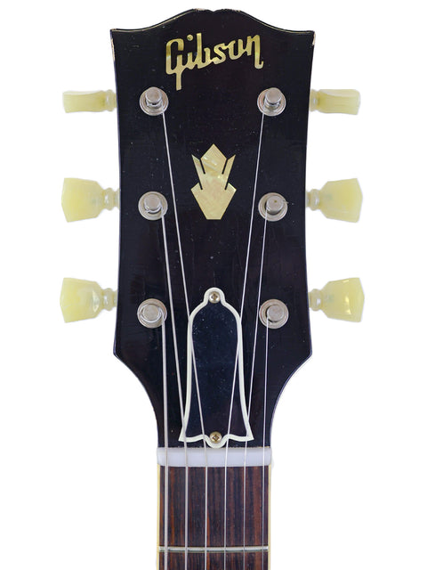 Close-up of the headstock from a Gibson Custom Shop '64 SG Murphy Lab guitar, highlighting its iconic features.