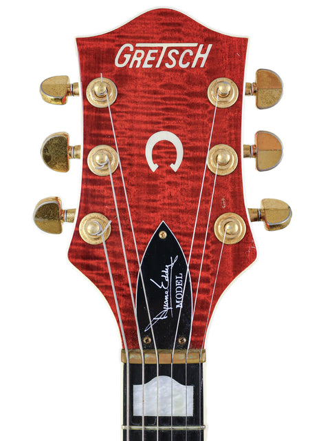 Close-up of the headstock from a Gretsch 6120DE Duane Eddy Signature guitar, featuring the iconic Gretsch logo.