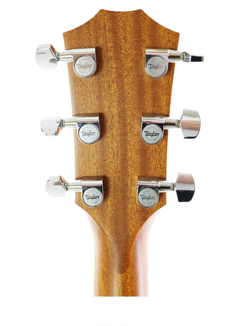 Close-up of the headstock on a 2011 Taylor 410CE acoustic guitar, showcasing four tuning knobs for easy tuning.