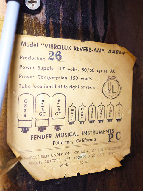 Close-up of the label on a 1966 Fender Vibrolux Reverb amplifier, revealing its unique vintage features and American heritage.