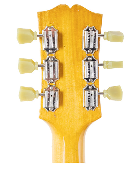 Close-up shot of a Sutton Archtop electric guitar neck from the 1970s, emphasizing its elegant curves and craftsmanship.
