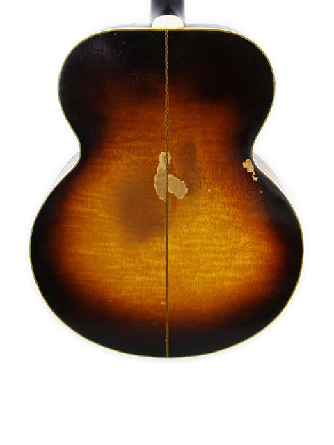 Close-up shot of a vintage Gibson J-200 from 1954, highlighting its rich sunburst finish.