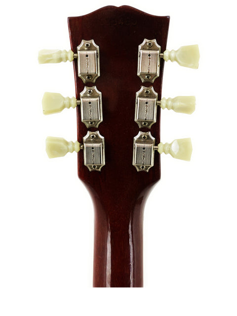 Close-up shot of the headstock from a 1963 Gibson ES-335 electric guitar, emphasizing its vintage style and quality.
