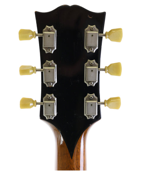 Close-up shot of the headstock on a 1952 Gibson ES-300 electric guitar, emphasizing its unique vintage style and hardware
