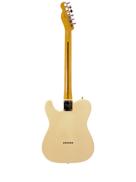Cream-colored electric guitar against a white background.