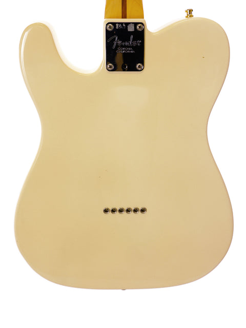 Cream-colored electric guitar body with black Fender neck plate on a white background.