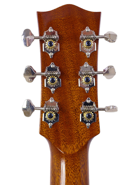 Detail of the headstock from a Maton Custom Shop Classic acoustic guitar, made in Australia in 2020, with four knobs.