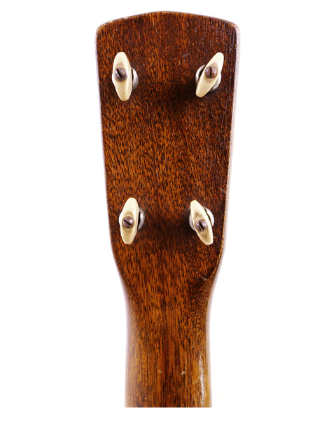 Detailed view of a 1927 Harmony Roy Smeck Vita-uke ukulele, highlighting the elegant wooden head and classic design.