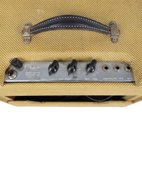 Detailed view of a 1952 Fender Tweed 5B3 Deluxe amplifier featuring a leather strap, highlighting its vintage appeal.