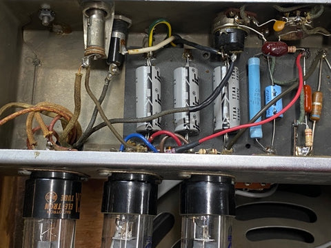Detailed view of a 1952 Fender Tweed 5B3 Deluxe metal box, featuring wires and electrical components in a vintage style.