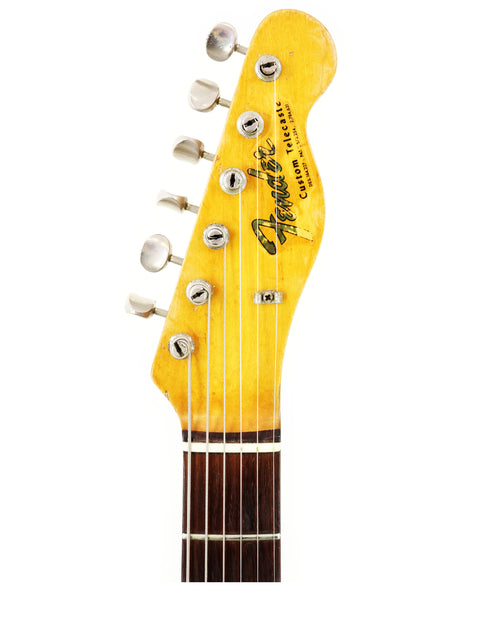 Detailed view of a 1966 Fender Custom Telecaster headstock featuring a yellow neck, highlighting its vintage craftsmanship.