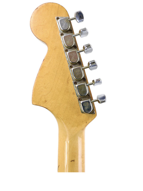 Detailed view of a 1970 USA Fender Stratocaster guitar head, set against a bright white background, highlighting its vintage charm.
