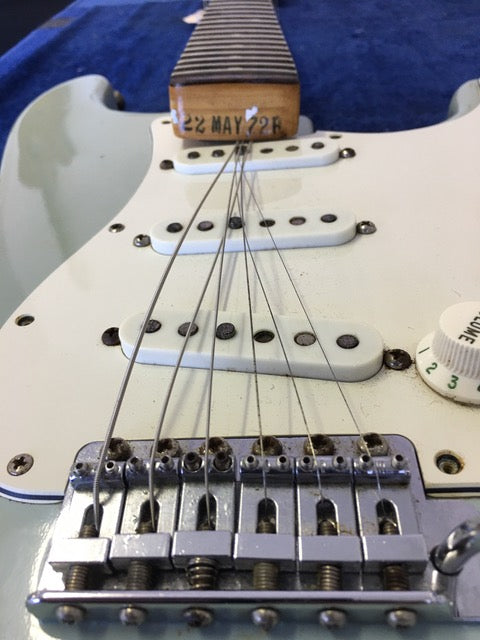 Detailed view of a 1972 Fender Stratocaster guitar pickup, emphasizing its vintage craftsmanship and iconic features.