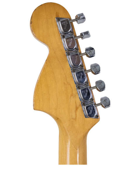 Detailed view of a 1972 Fender Stratocaster neck, highlighting its vintage refinishing and iconic craftsmanship.
