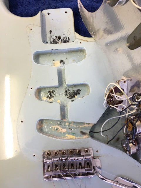 Detailed view of a 1972 Fender Stratocaster's interior, highlighting wires and connections in this vintage guitar.