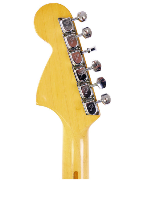 Detailed view of a 1979 Fender Stratocaster headstock, featuring a vibrant yellow body that highlights its classic style.