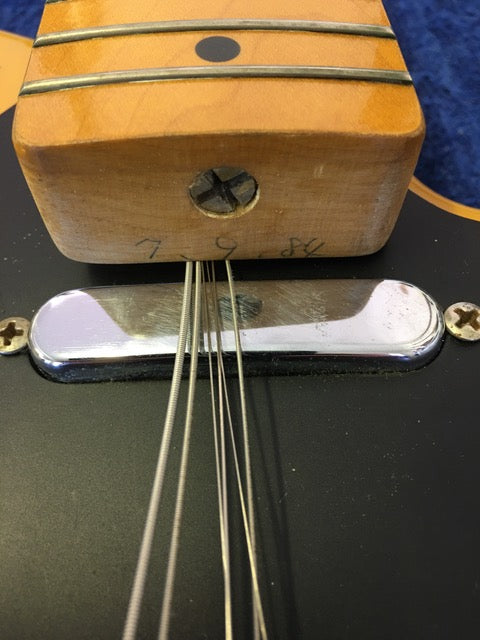 Detailed view of a 1984 Fender Squier JV Telecaster guitar, featuring a string attached, emphasizing its classic craftsmanship.