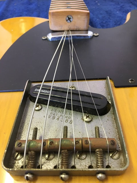 Detailed view of a 1984 Fender Squier JV Telecaster guitar, highlighting the pickup and strings.