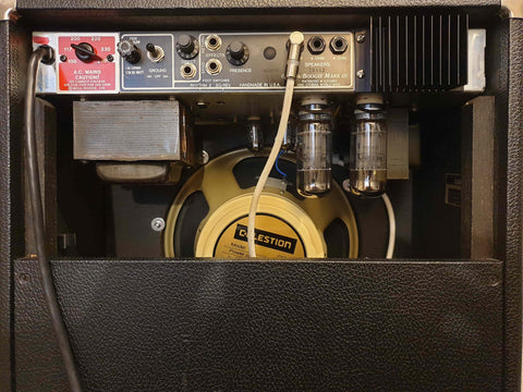 Detailed view of a 1987 Mesa Boogie Mark III guitar amplifier, highlighting the speaker and intricate design features.