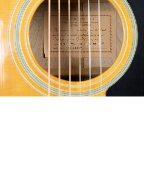 Detailed view of a 1992 Maton Stage Deluxe Rock Maple acoustic guitar, highlighting the label and craftsmanship of the instrument.