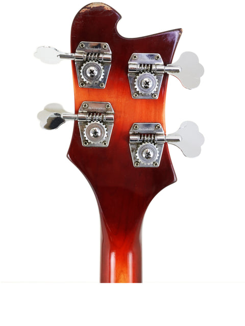 Detailed view of a 1997 Rickenbacker 4003 Fireglo Bass guitar head with three strings, highlighting its craftsmanship.