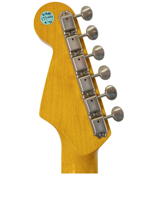 Detailed view of a 2012 Warmoth Strat Partscaster guitar head, showcasing a colorful sticker on its surface.