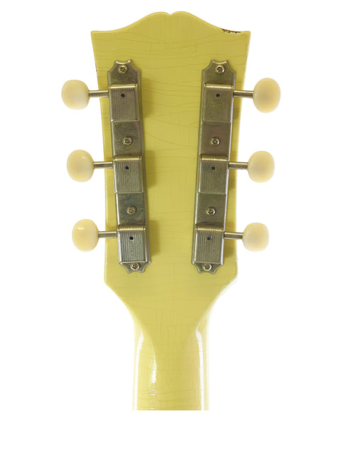 Detailed view of a Gibson Custom ‘63 SG Special headstock with four knobs, highlighting its elegant features and finish.
