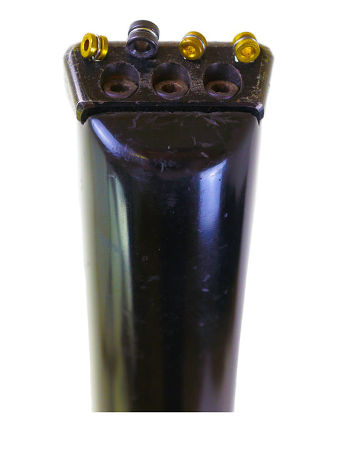 Detailed view of a black cylinder featuring four screws, associated with the 1982 Steinberger L2 Bass from the USA.