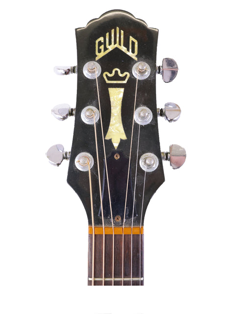 Detailed view of a guitar headstock showcasing a crown logo, identifying it as a 1989 USA-made Guild D40.
