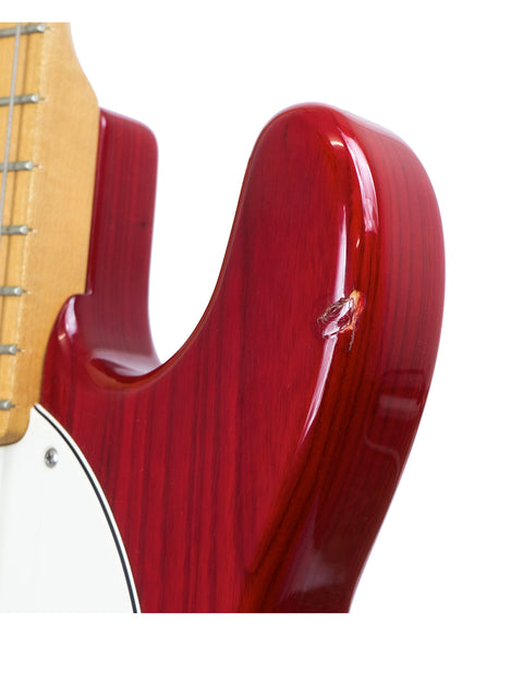 Detailed view of a red electric guitar, the Music Man Stingray 4 H Bass from 2008, highlighting its craftsmanship.