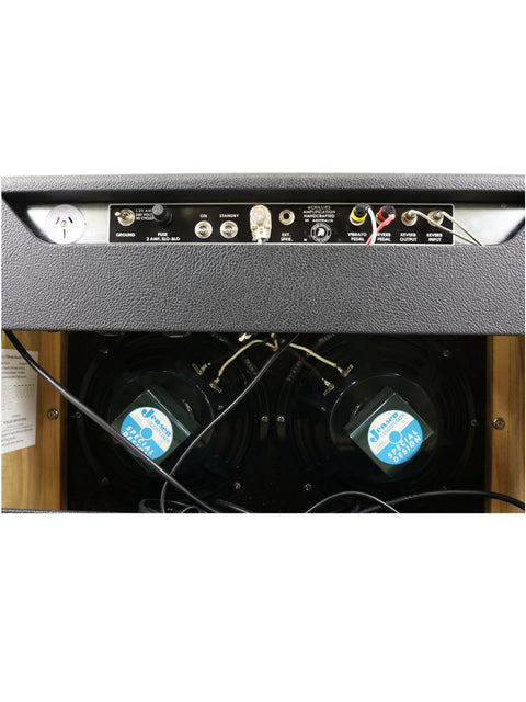 Detailed view of the Achillies Vibrolux Reverb Combo Amp, featuring wires and a microphone on its speaker cabinet.
