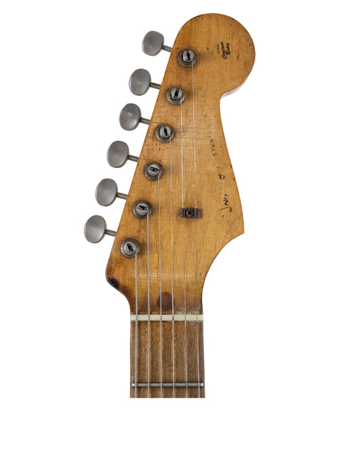 Detailed view of the headstock from a 1958 USA Fender Stratocaster electric guitar, highlighting its iconic shape and features.