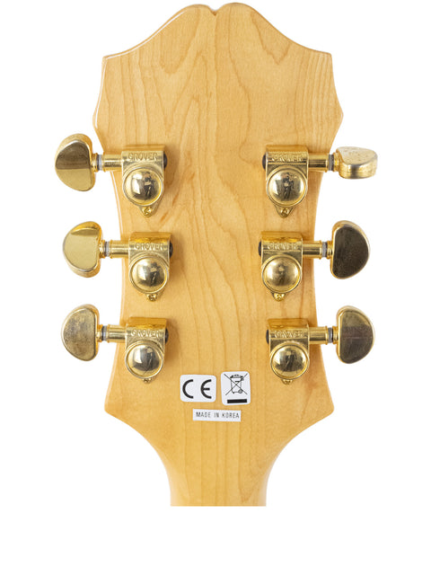 Detailed view of the headstock from a 1965 Epiphone Coronet electric guitar, highlighting its classic features and craftsmanship.
