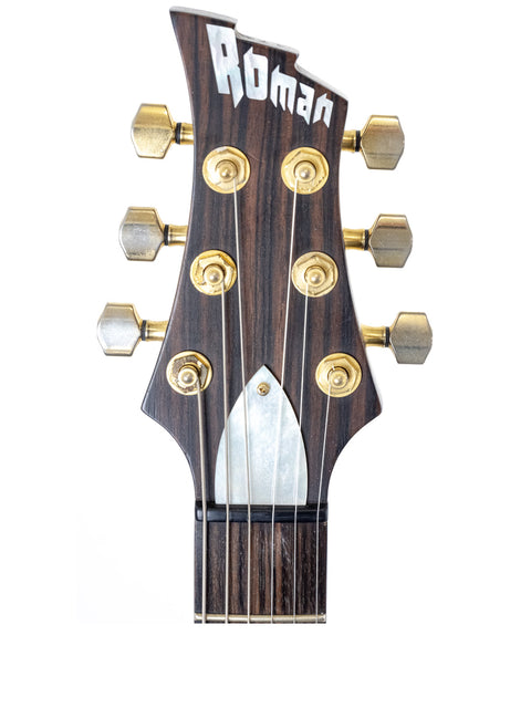 Detailed view of the headstock from a 2004 Ed Roman Quicksilver electric guitar, highlighting its PRS-style features and finish.