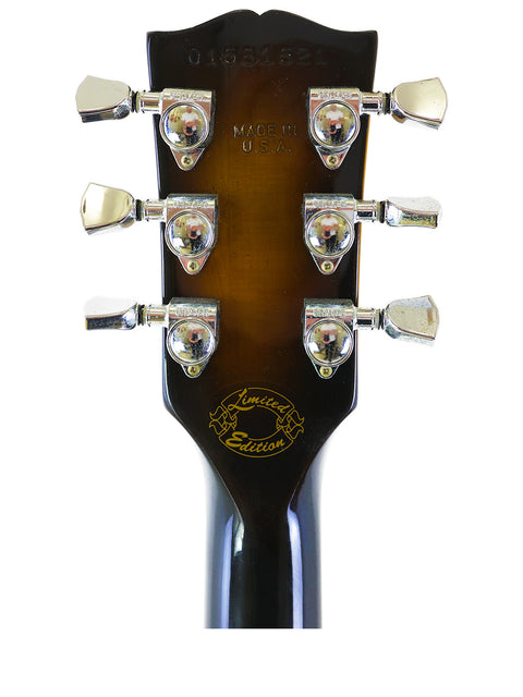Detailed view of the headstock of a 2001 Gibson ES-135 electric guitar, highlighting its classic features and finish.