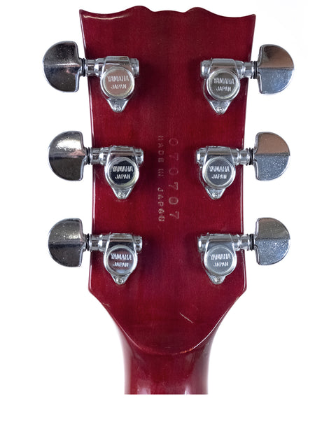 Detailed view of the headstock on a 1981 Yamaha SG 800S electric guitar, highlighting its classic features.