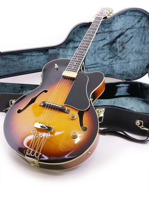 Displaying a Yamaha AEX1500 guitar in its case, the image features a simple white background for emphasis.
