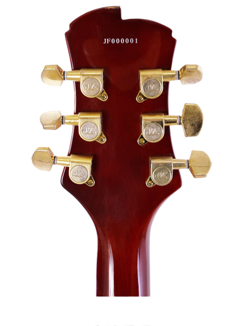 Electric guitar headstock with gold hardware, showcasing Jarrett Forza, Serial #00001, made in the USA in 2007.
