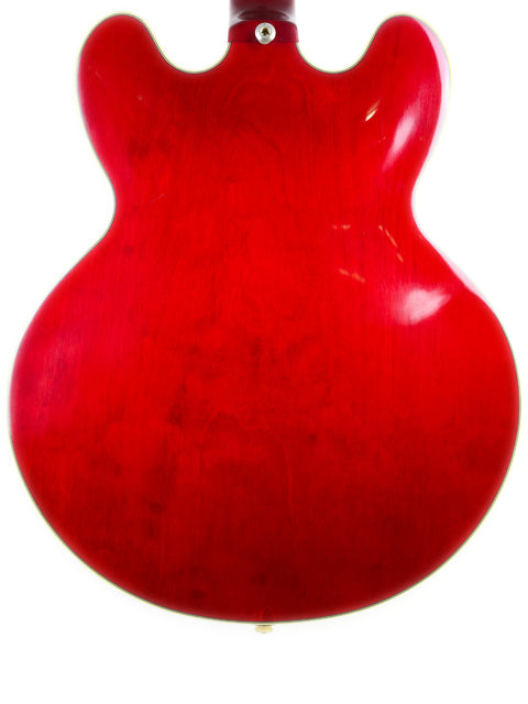 The Epiphone 50th Anniversary 1962 Sheraton E212T Reissue features a vibrant red guitar with a sleek white body and neck.
